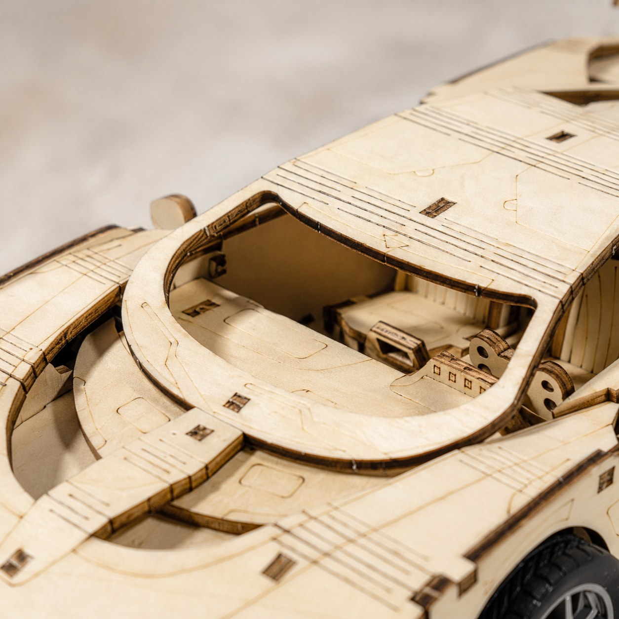 Macro close-up of the laser-cut wood details on the supercar model