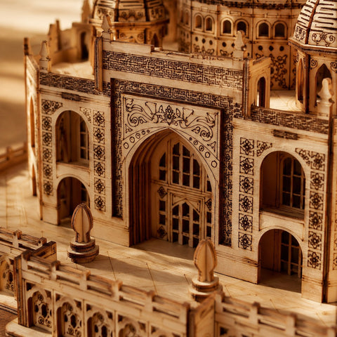 Macro close-up showing the precision laser-engraved floral motifs and archways of the wooden Taj Mahal