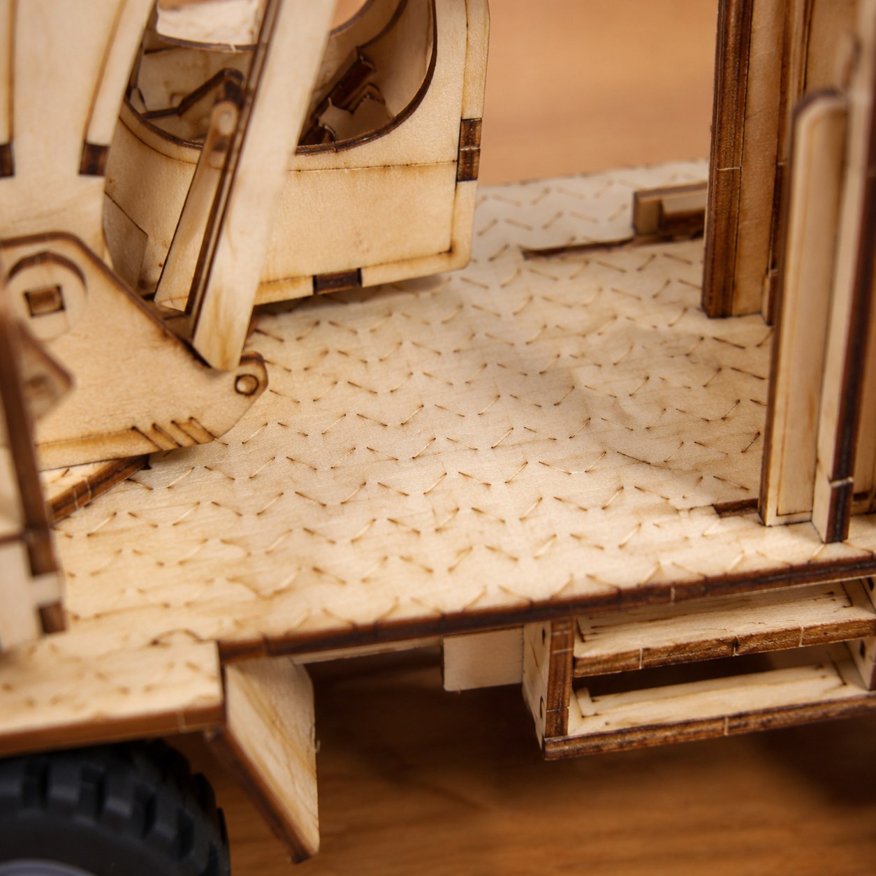 Close-up of laser-cut wood details on the excavator model