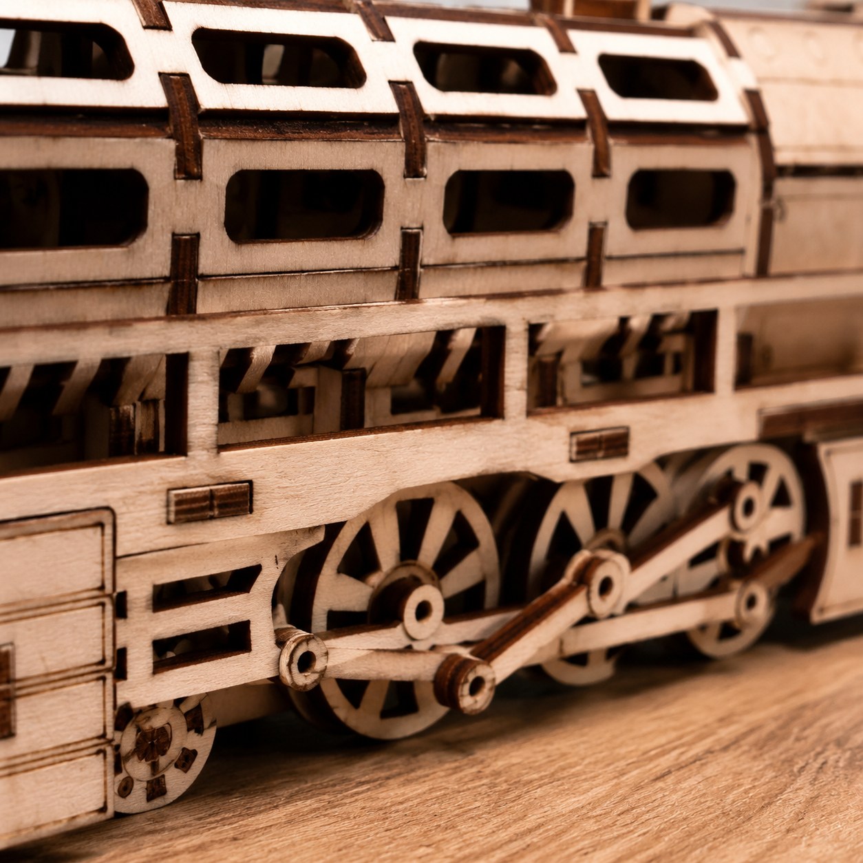Macro close-up of laser-cut wooden wheels and interlocking joints
