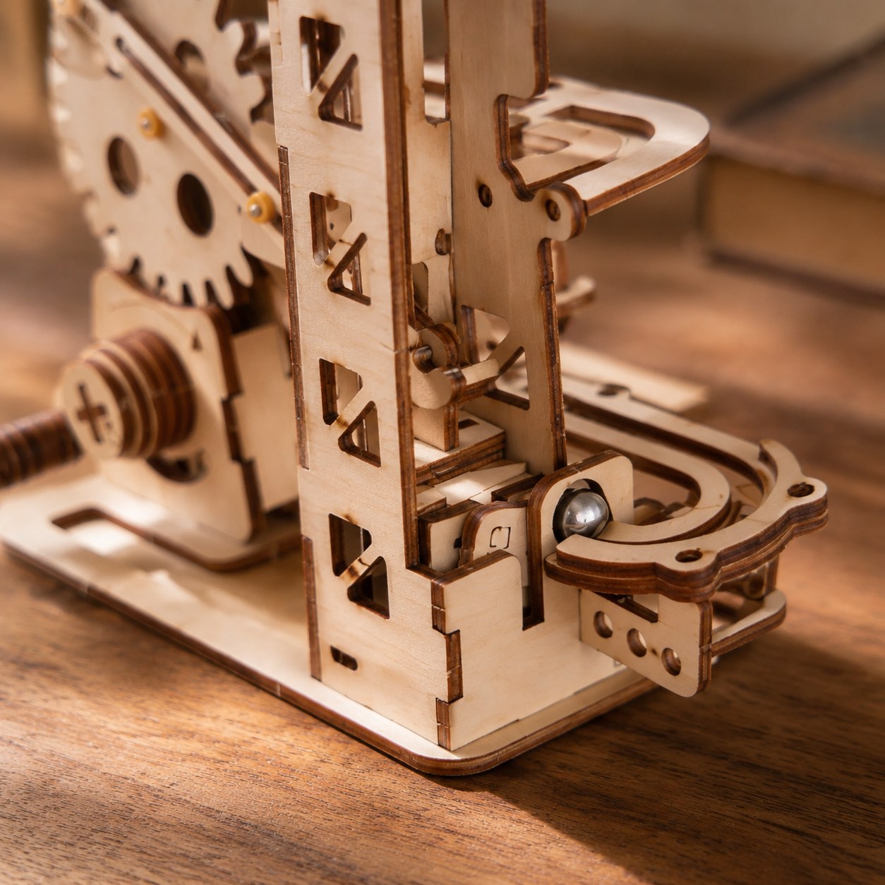 Close-up of laser-cut wooden gears and metal ball bearing