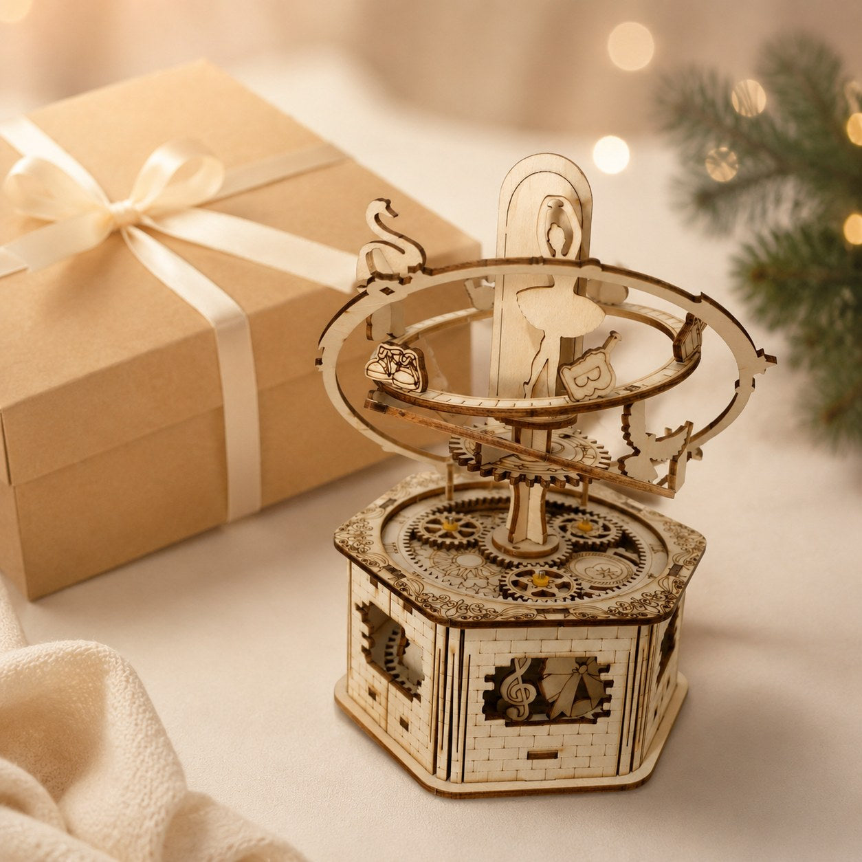 Orbiting Ballerina wooden music box displayed next to a wrapped gift box