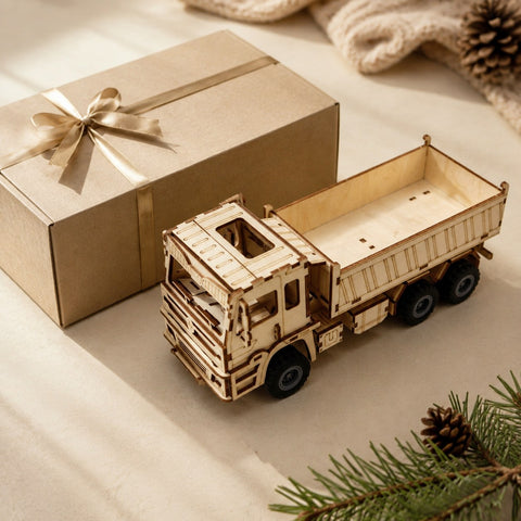Wooden dump truck model next to a gift box