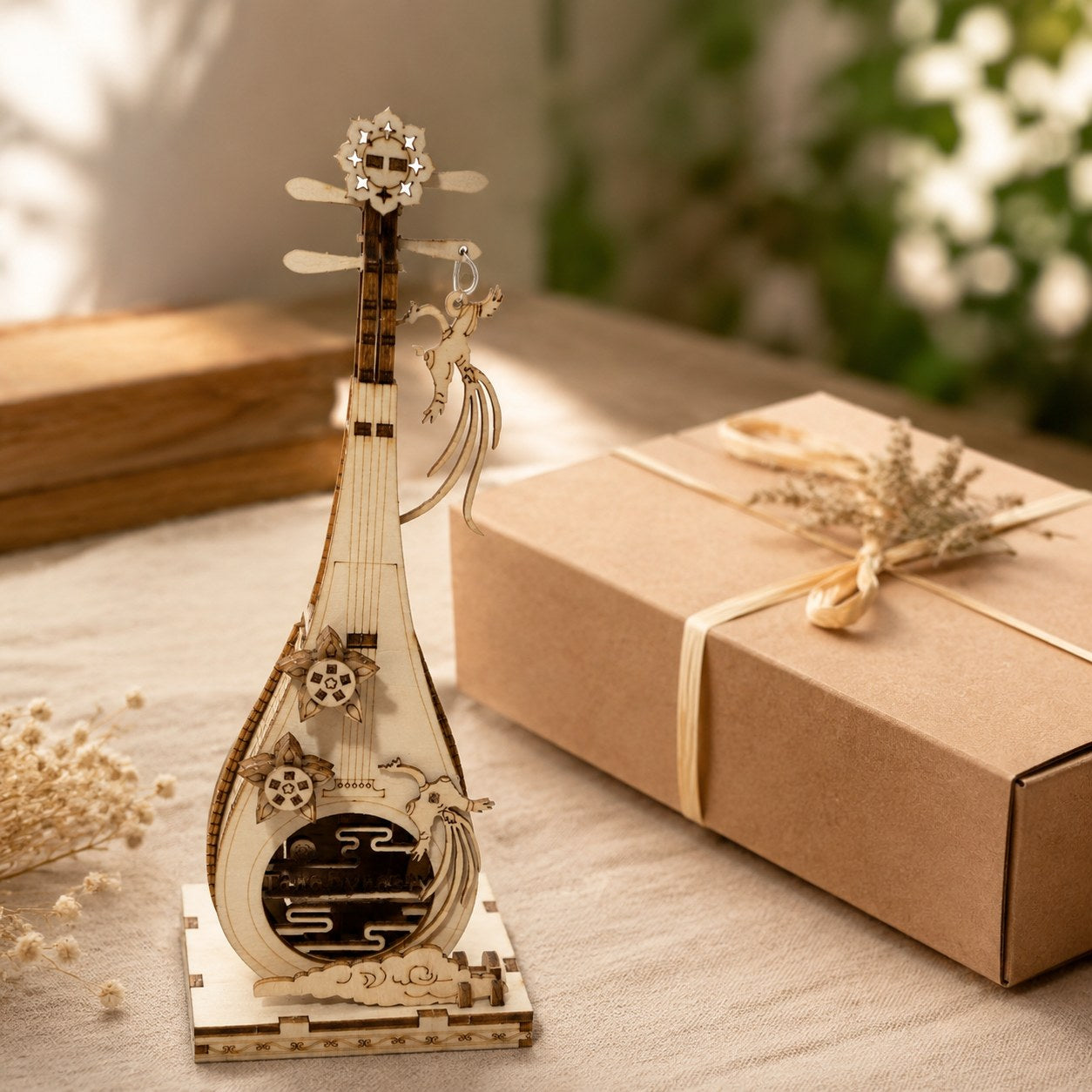 Finished wooden Pipa model displayed next to a wrapped gift box