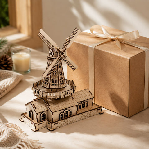 Finished wooden windmill model displayed next to a gift box