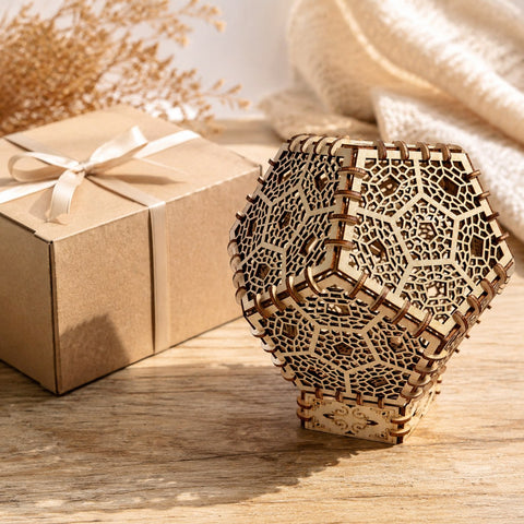 Geometric wooden lantern puzzle next to a gift box