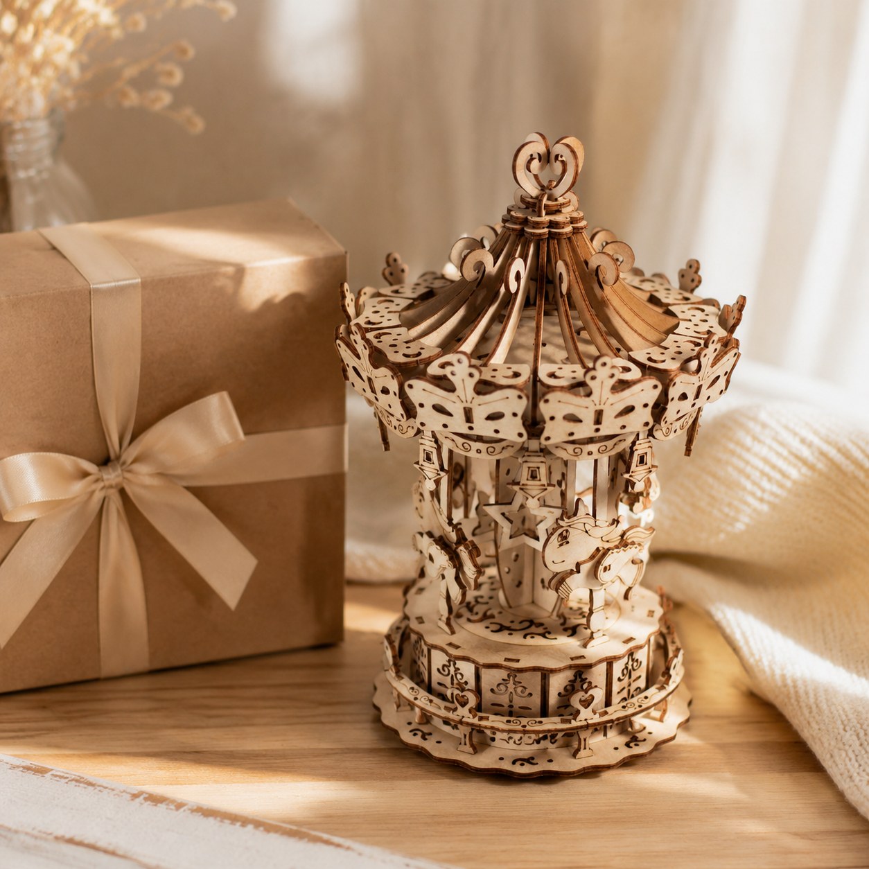 Finished wooden carousel puzzle displayed next to a beautiful gift box