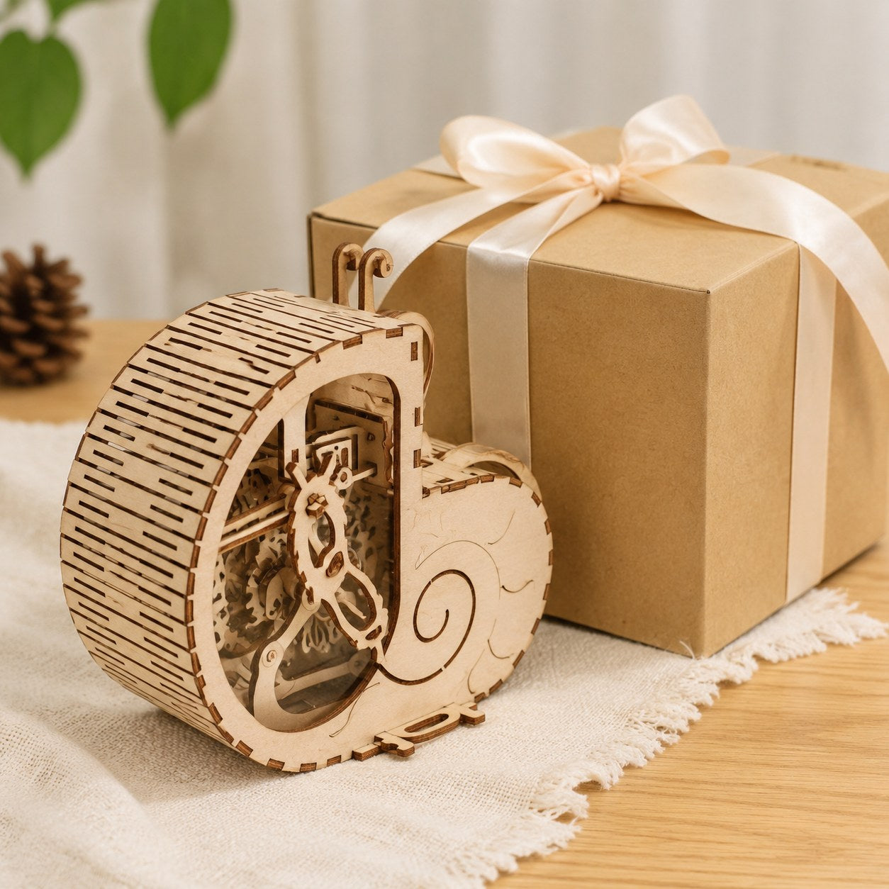Wooden snail coin bank next to a gift box