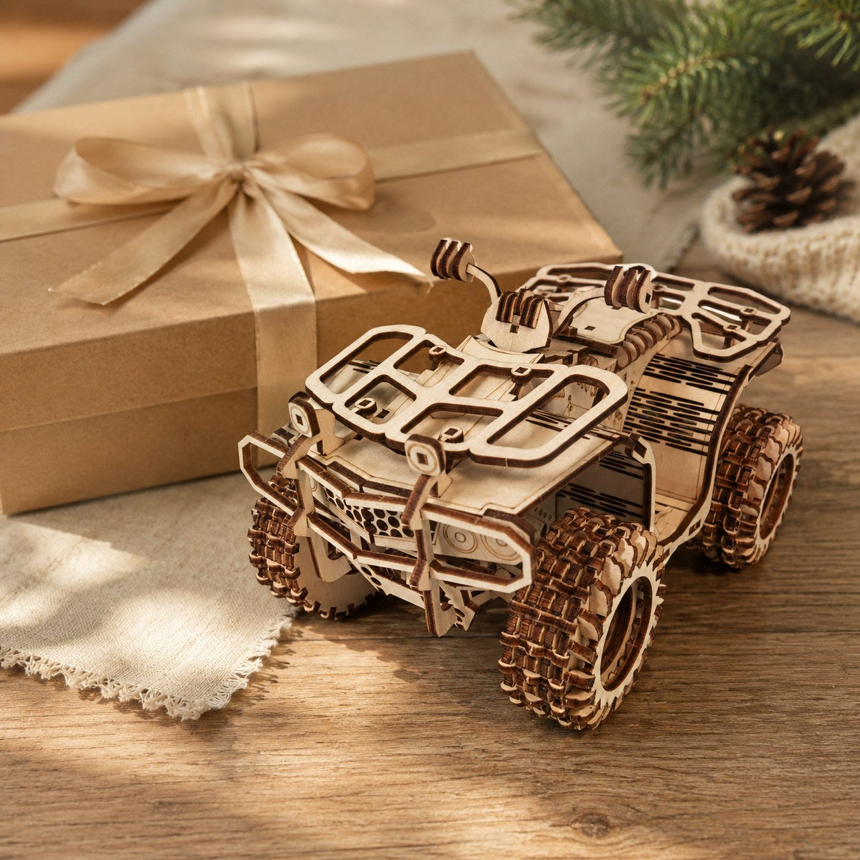 Wooden ATV model displayed next to a kraft gift box.