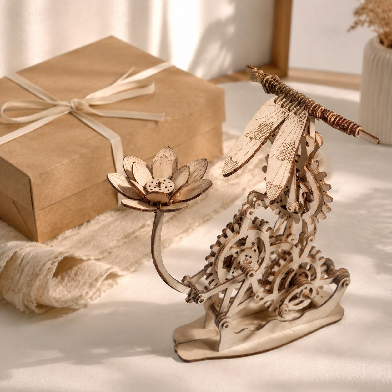 Kinetic Hovering Dragonfly 3D Wooden Puzzle next to a gift box
