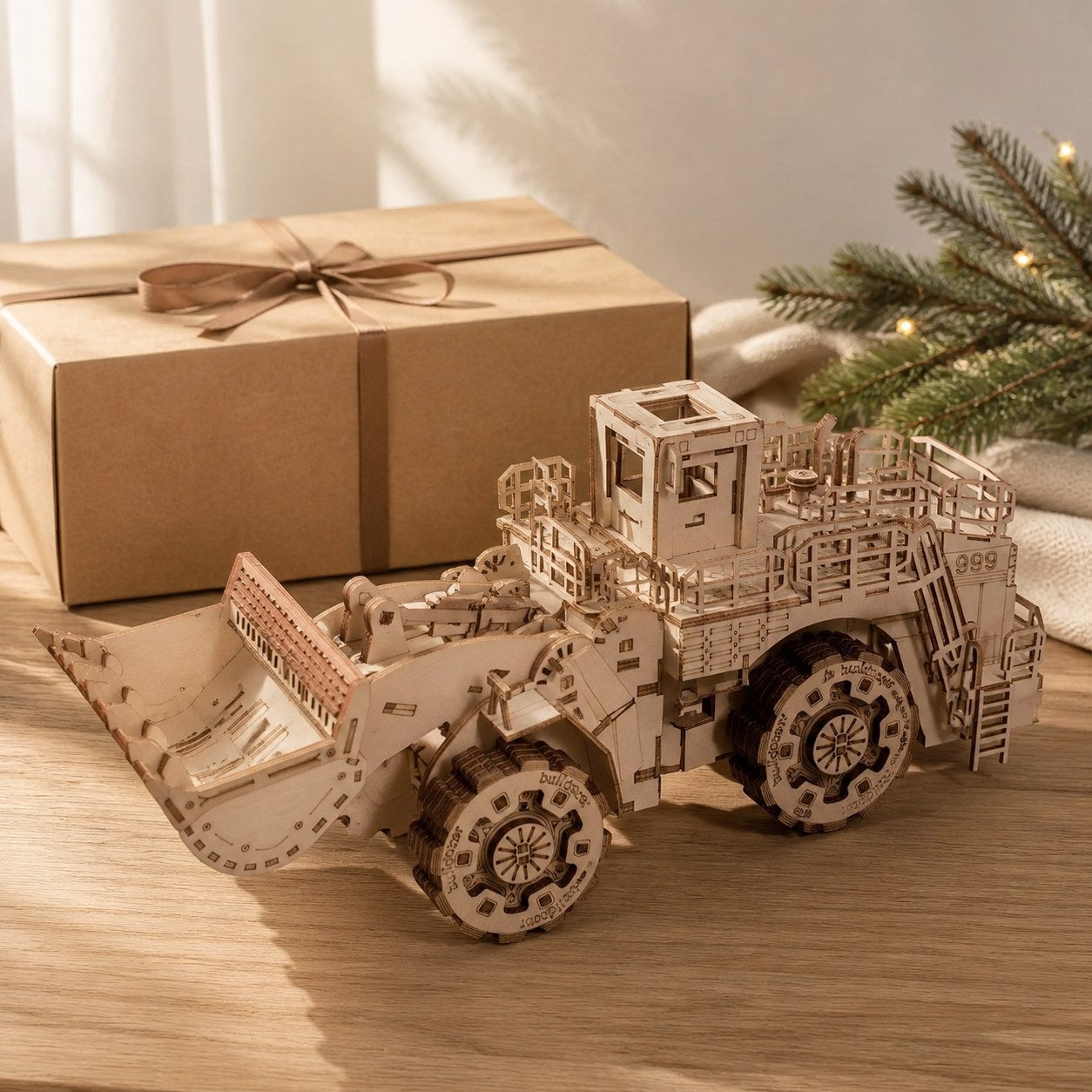 Wooden bulldozer model kit next to a gift box