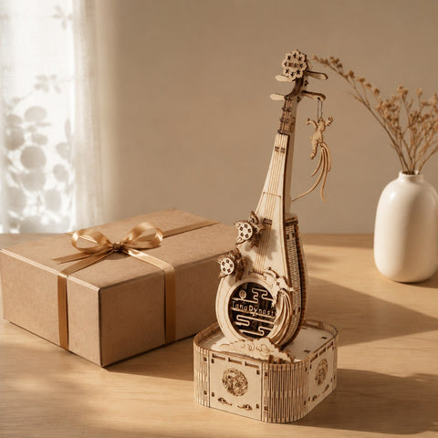 Finished Pipa 3D wooden puzzle displayed next to a wrapped gift box