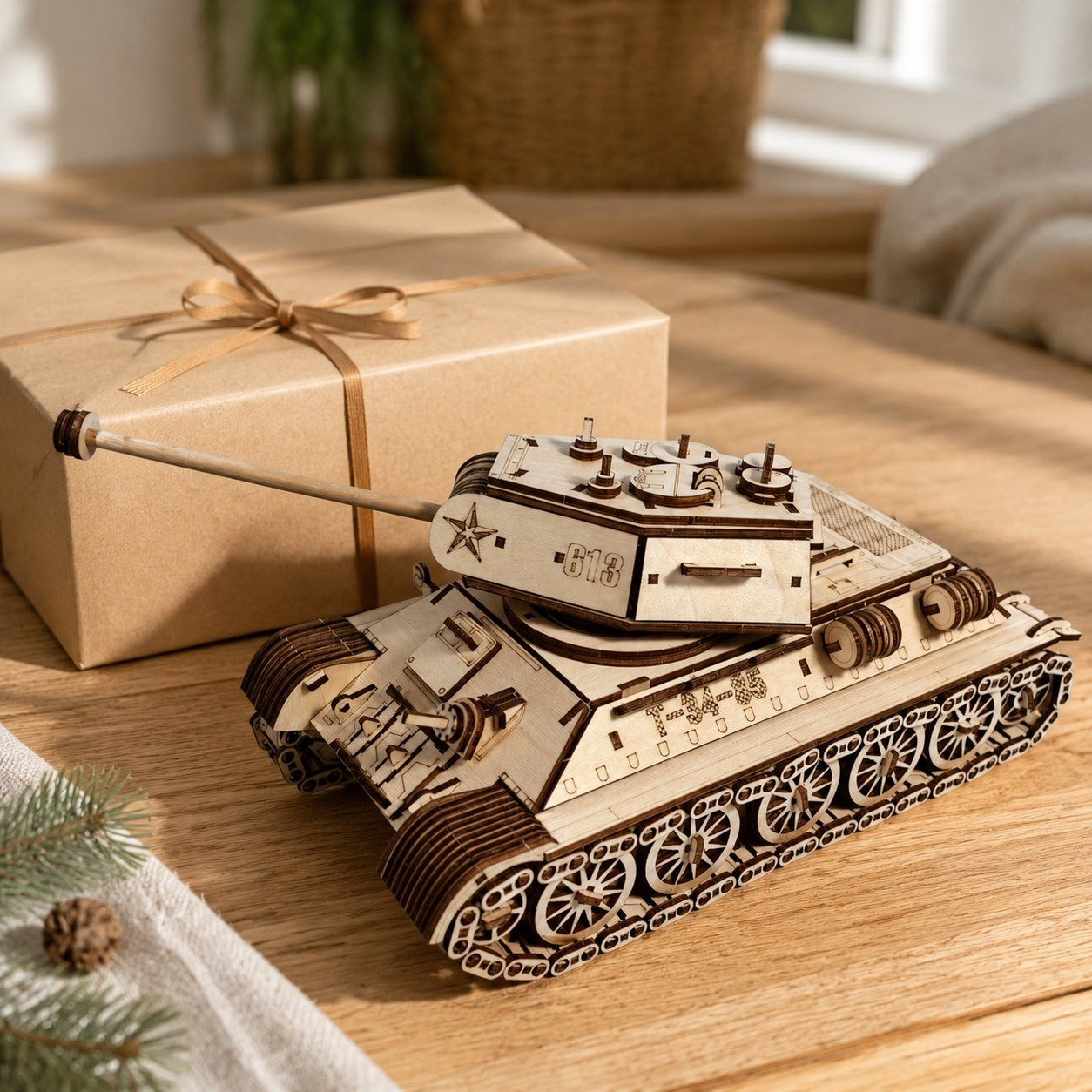 Wooden tank model next to a kraft gift box