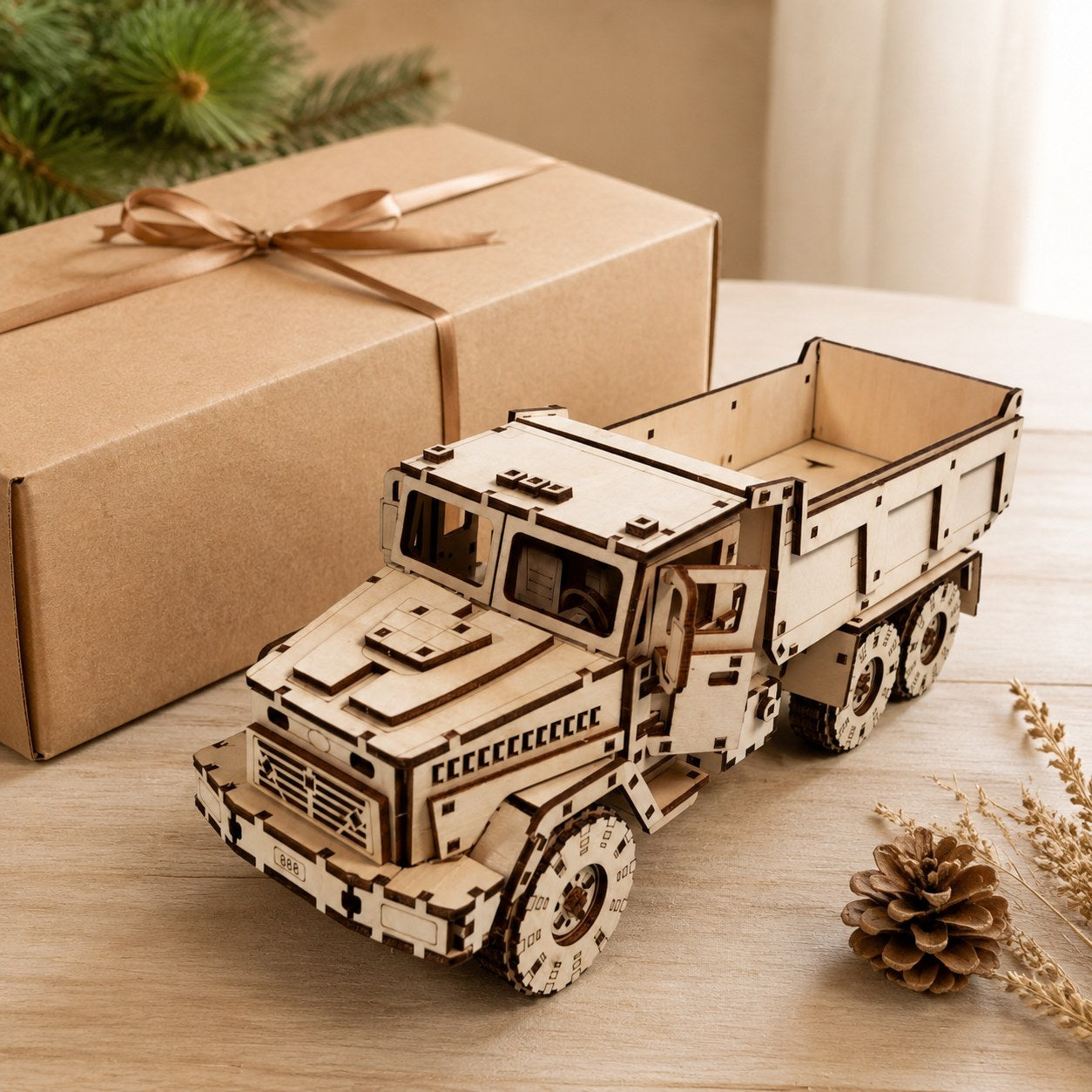 Finished wooden dump truck model displayed next to a kraft gift box
